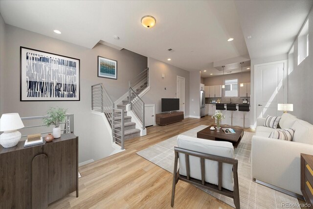 1632 Lowell Blvd Unit 5, Denver, CO 80204 - living room with stairway, light wood-style flooring, and recessed lighting