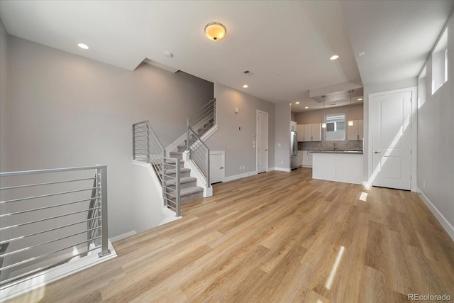 1632 Lowell Blvd Unit 5, Denver, CO 80204 - unfurnished living room with light wood-style flooring and recessed lighting