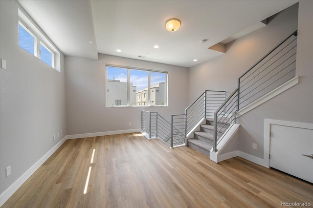 1632 Lowell Blvd Unit 5, Denver, CO 80204 - unfurnished living room featuring wood finished floors, stairway, and recessed lighting