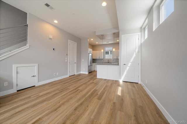 1632 Lowell Blvd Unit 5, Denver, CO 80204 - unfurnished living room featuring light wood finished floors and recessed lighting