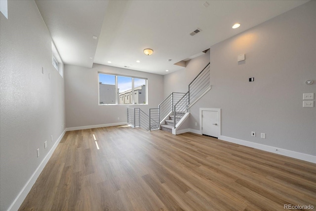 1632 Lowell Blvd Unit 5, Denver, CO 80204 - unfurnished living room featuring stairs, wood finished floors, and recessed lighting