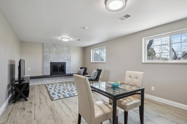 3406 E Fair Pl, Centennial, CO 80121 - dining room featuring light wood-type flooring and a fireplace