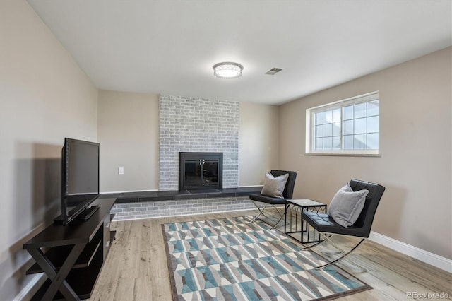 3406 E Fair Pl, Centennial, CO 80121 - sitting room featuring wood finished floors and a brick fireplace