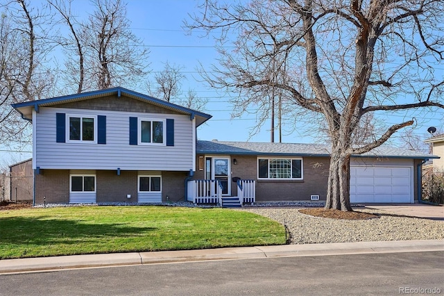 3406 E Fair Pl, Centennial, CO 80121 - tri-level home featuring brick siding, driveway, an attached garage, and a front lawn