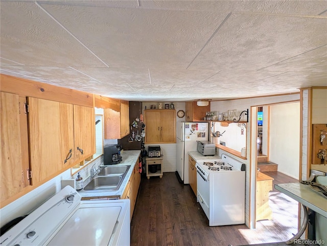 kitchen with separate washer and dryer, white appliances, dark hardwood / wood-style floors, and sink