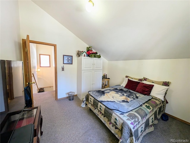 carpeted bedroom with lofted ceiling