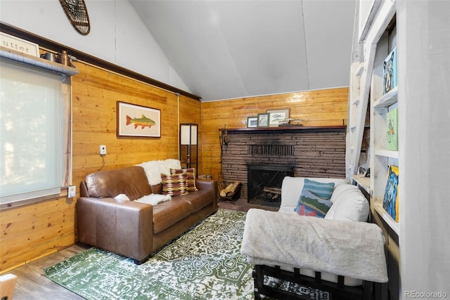 living room with a stone fireplace, wood walls, vaulted ceiling, and wood-type flooring