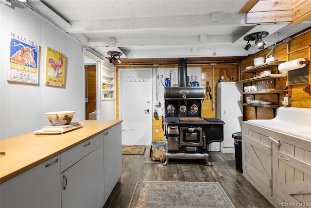 interior space featuring dark hardwood / wood-style floors and wooden walls