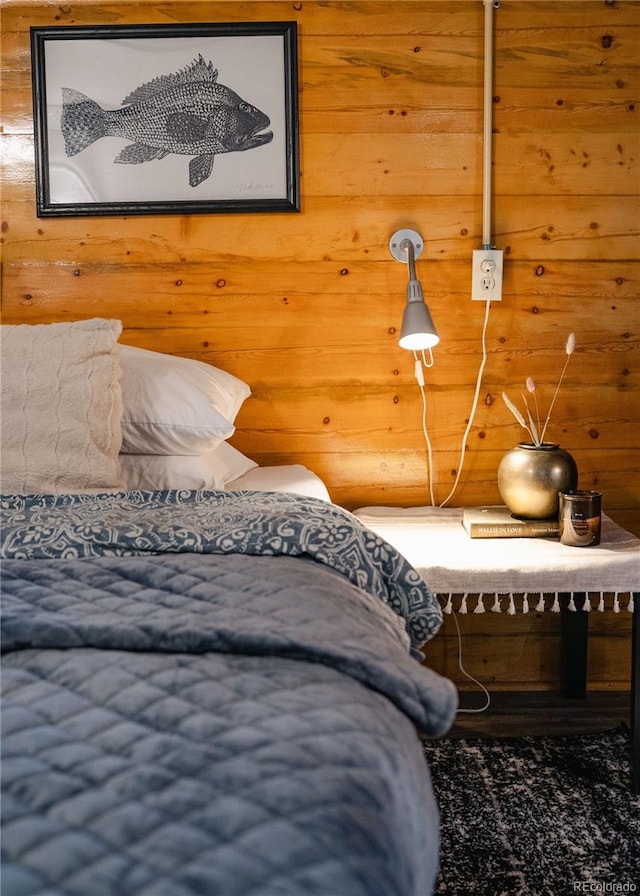 bedroom featuring wood walls