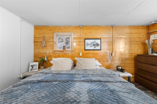 bedroom with wood walls