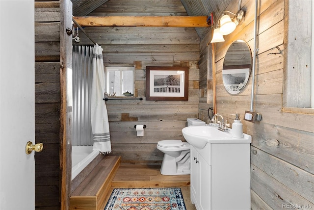 full bathroom with toilet, wooden walls, vanity, and hardwood / wood-style floors