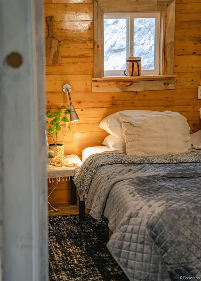 bedroom with wooden walls