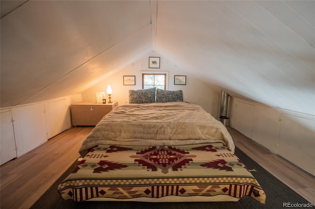 bedroom with light hardwood / wood-style flooring and lofted ceiling