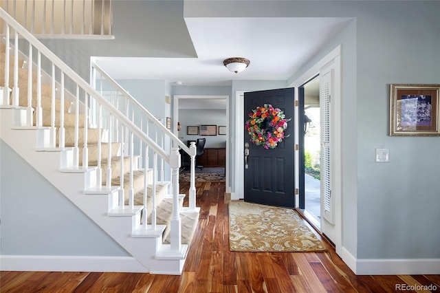 10886 E Berry Ave, Englewood, CO 80111 - entryway featuring baseboards, stairway, and wood finished floors