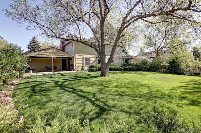 10886 E Berry Ave, Englewood, CO 80111 - view of grassy yard with a patio area