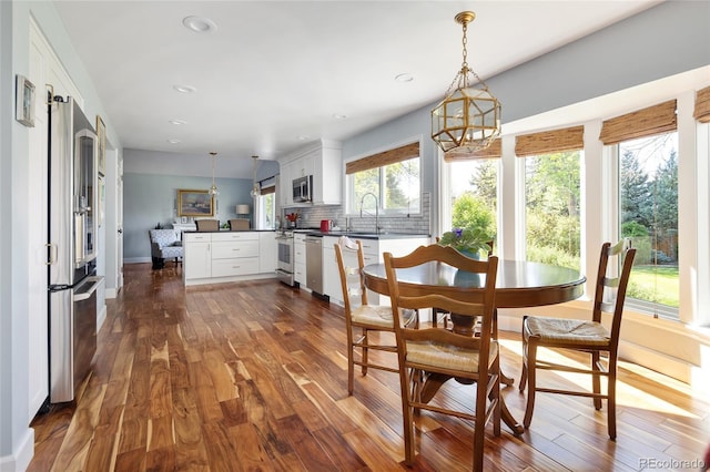 10886 E Berry Ave, Englewood, CO 80111 - dining space featuring dark wood-type flooring, a chandelier, recessed lighting, and baseboards