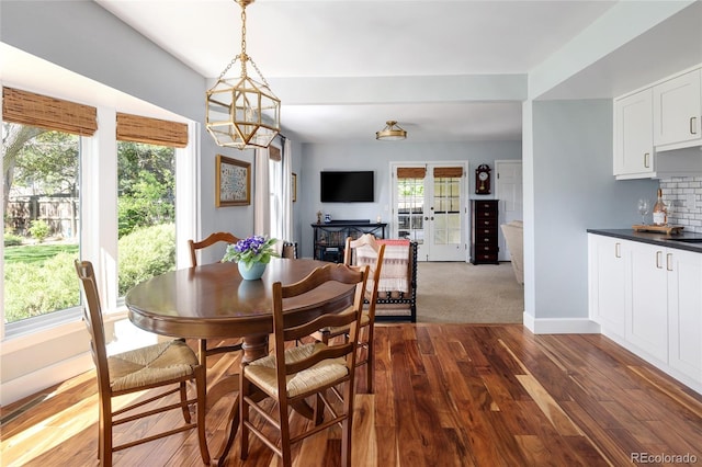 10886 E Berry Ave, Englewood, CO 80111 - dining room featuring dark wood-style flooring, a chandelier, and baseboards