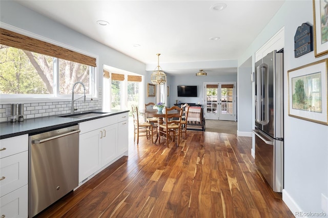 10886 E Berry Ave, Englewood, CO 80111 - kitchen featuring stainless steel appliances, a sink, dark countertops, dark wood finished floors, and recessed lighting