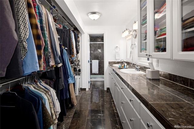 10886 E Berry Ave, Englewood, CO 80111 - bathroom with vanity, a walk in closet, a stall shower, and marble finish floors