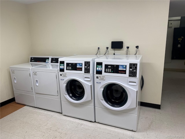 shared laundry room featuring washer and clothes dryer and baseboards