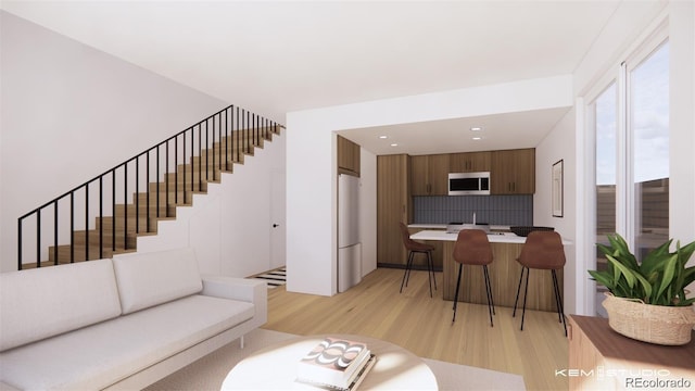 living room featuring light wood-type flooring, stairs, and recessed lighting