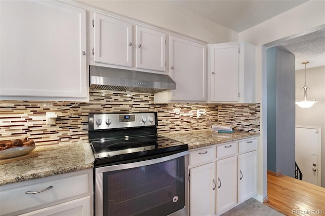 kitchen with white cabinetry, electric stove, backsplash, under cabinet range hood, and light stone counters