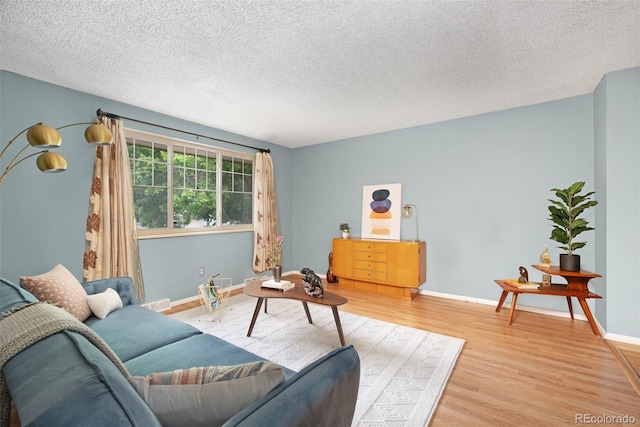 12642 E Ohio Ave, Aurora, CO 80012 - living room with light wood finished floors, baseboards, and a textured ceiling