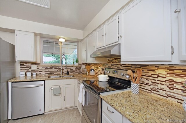 12642 E Ohio Ave, Aurora, CO 80012 - kitchen featuring stainless steel appliances, under cabinet range hood, a sink, white cabinets, and decorative backsplash