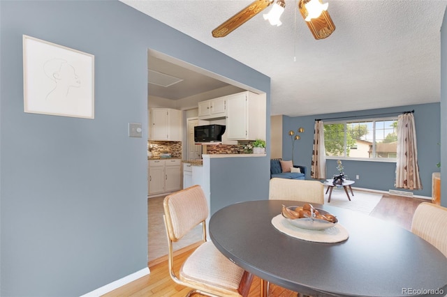 12642 E Ohio Ave, Aurora, CO 80012 - dining space with light wood-style flooring, ceiling fan, a textured ceiling, and baseboards