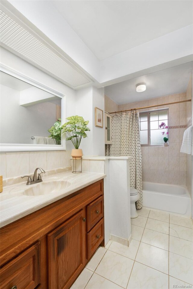 12642 E Ohio Ave, Aurora, CO 80012 - full bathroom with vanity, tile patterned flooring, shower / tub combo with curtain, and toilet