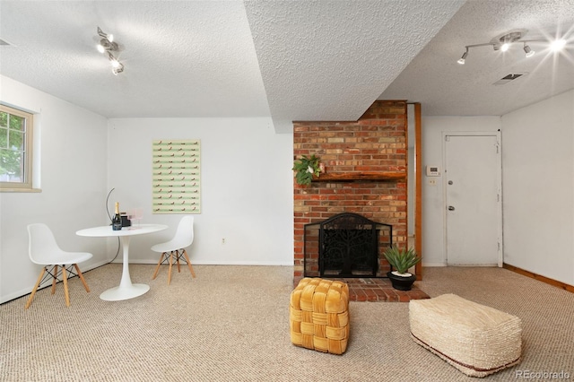 12642 E Ohio Ave, Aurora, CO 80012 - carpeted living room with a textured ceiling, baseboards, track lighting, and a brick fireplace