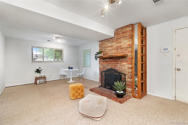12642 E Ohio Ave, Aurora, CO 80012 - living area with carpet floors, a brick fireplace, a textured ceiling, and baseboards
