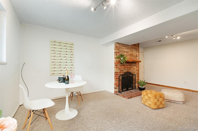 12642 E Ohio Ave, Aurora, CO 80012 - dining room featuring carpet floors, track lighting, a brick fireplace, baseboards, and a textured ceiling