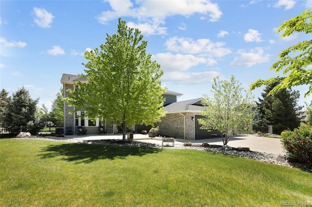 14712 Kalamath Ct, Westminster, CO 80023 - rear view of property with stone siding, concrete driveway, and a garage