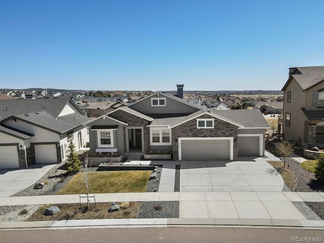 1877 Walnut Creek Ct, Colorado Springs, CO 80921 - view of front facade with a residential view, concrete driveway, a garage, and stone siding