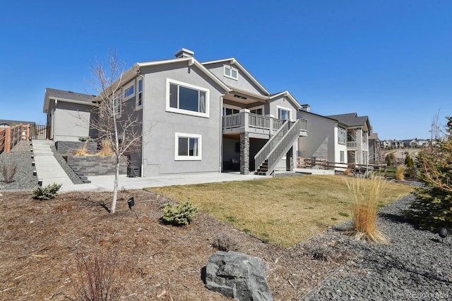 1877 Walnut Creek Ct, Colorado Springs, CO 80921 - back of property with stairway, a patio area, stucco siding, and a wooden deck