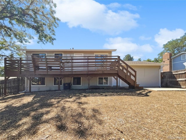 rear view of house featuring stairs, central AC, a wooden deck, and fence