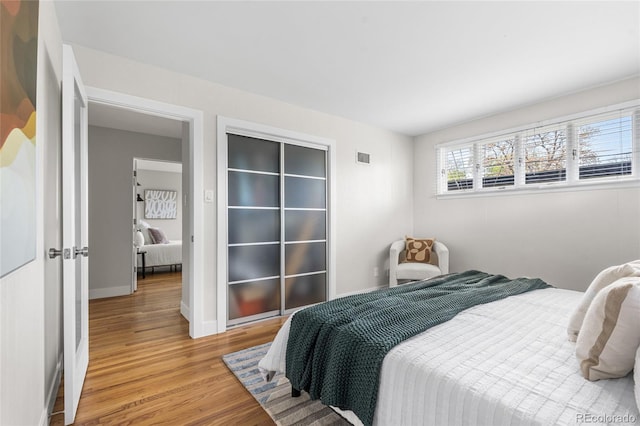 8955 E 19th Ave, Aurora, CO 80010 - bedroom featuring light wood-type flooring and baseboards