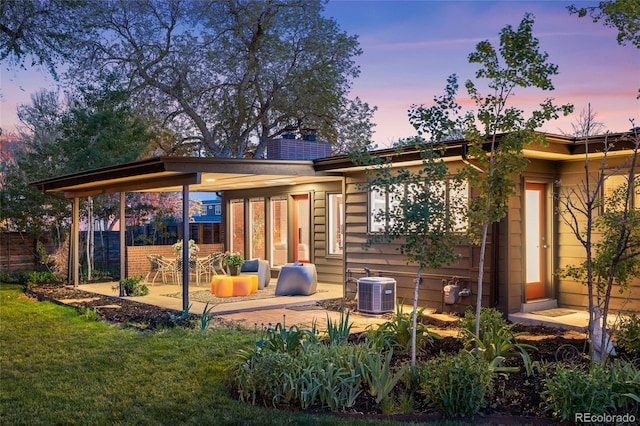 8955 E 19th Ave, Aurora, CO 80010 - back of property at dusk with a patio and central AC