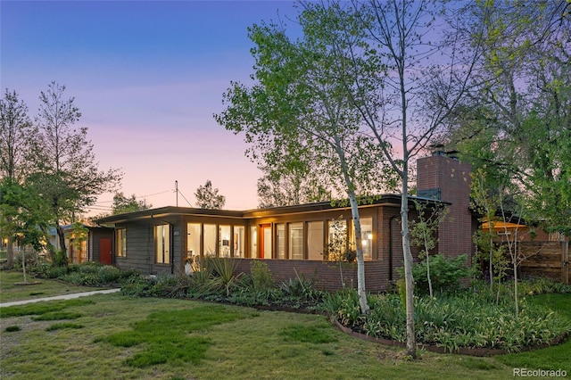 8955 E 19th Ave, Aurora, CO 80010 - mid-century home with a chimney, a front lawn, and brick siding