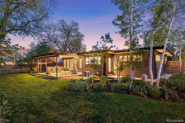 8955 E 19th Ave, Aurora, CO 80010 - back of property at dusk with a patio area and central AC unit