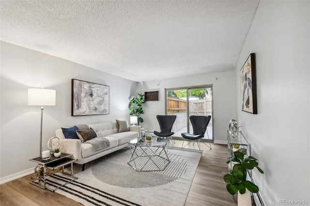 living room with hardwood / wood-style flooring and a textured ceiling