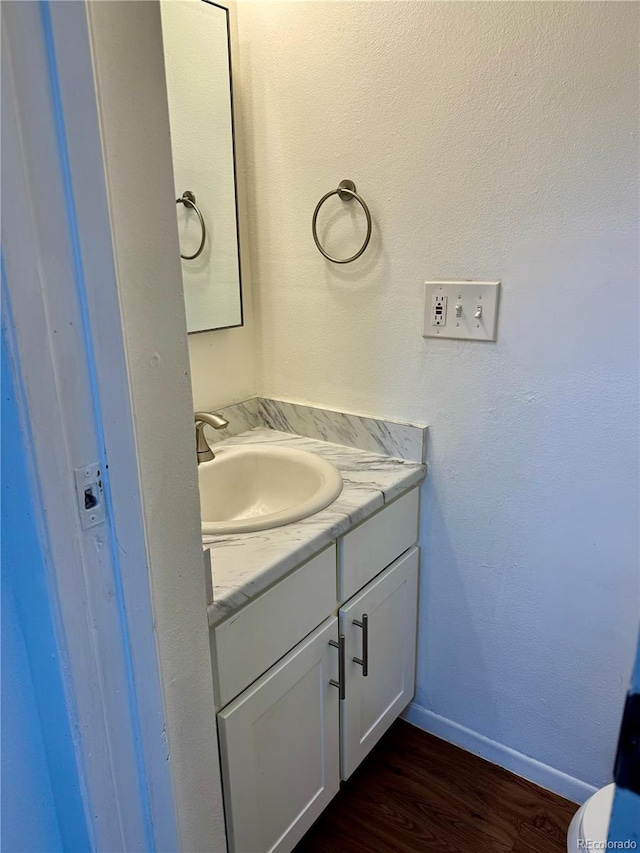 bathroom featuring hardwood / wood-style floors and vanity