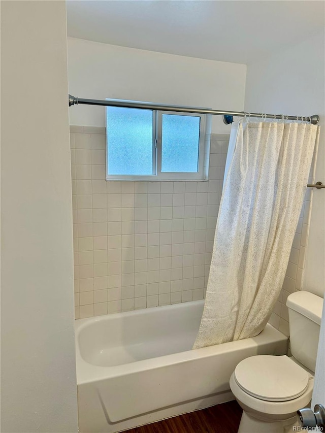 bathroom with toilet, shower / bath combination with curtain, and hardwood / wood-style floors