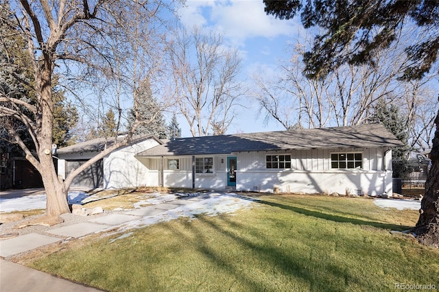 ranch-style home featuring board and batten siding and a front yard