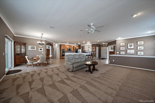 unfurnished living room featuring light tile patterned floors, light colored carpet, ornamental molding, baseboards, and ceiling fan with notable chandelier