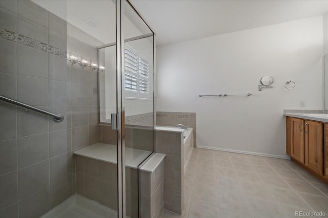 full bathroom featuring a garden tub, a shower stall, tile patterned flooring, and vanity