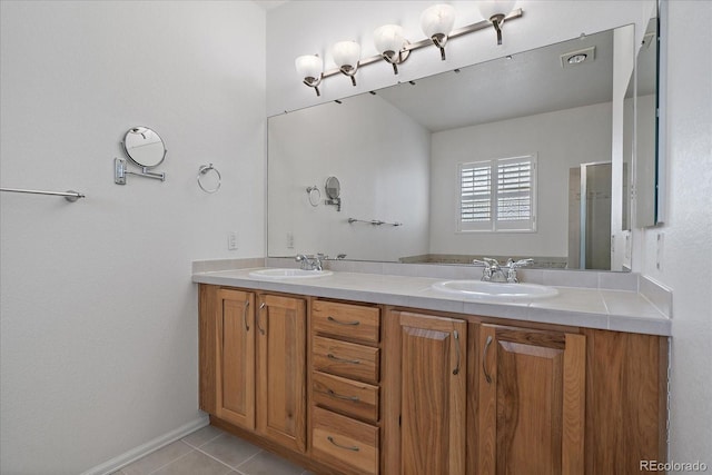 bathroom featuring tile patterned flooring, visible vents, a sink, and double vanity