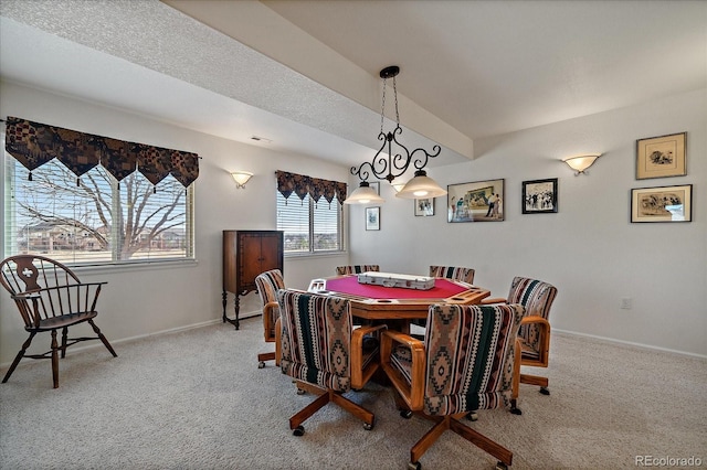 dining area with light carpet, a textured ceiling, and baseboards