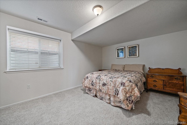 carpeted bedroom with a textured ceiling, visible vents, and baseboards